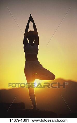 Silhouette of a person standing on one leg during sunset View Large Photo Image Stock Image - Silhouette of a person standing on one leg during sunset. Fotosearch