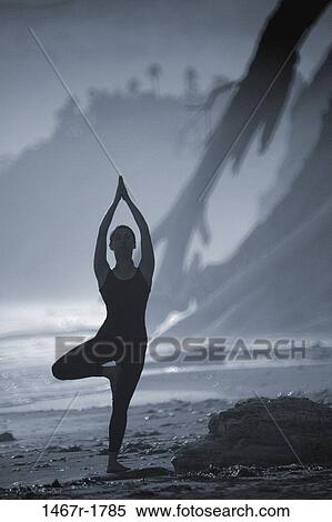 Silhouette of a woman standing on one leg at the beach View Large Photo Image Stock Photography - Silhouette of a woman standing on one leg at the beach. Fotosearch