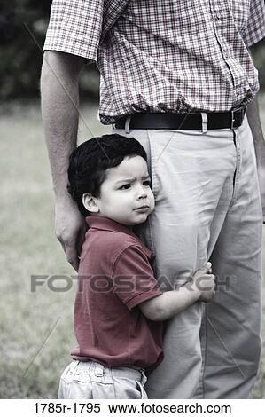 Son holding his father by his leg View Large Photo Image Stock Photography - Son holding his father by his leg. Fotosearch