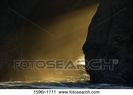 Sunbeams through a natural arch, Bandon State Park, Oregon, USA View Large Photo Image Stock Image - Sunbeams through a natural arch, Bandon State Park, Oregon, USA. Fotosearch