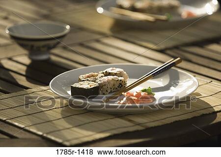 Sushi served with chopsticks on dining table View Large Photo Image Stock Photo - Sushi served with chopsticks on dining table. Fotosearch