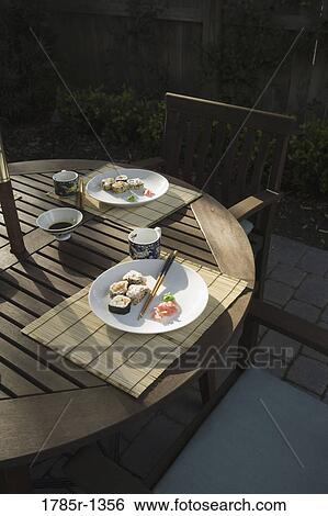 Sushi served with chopsticks View Large Photo Image Stock Photograph - Sushi served with chopsticks. Fotosearch