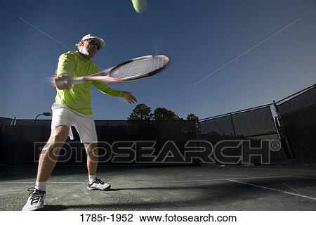 Tennis player hitting a backhand View Large Photo Image Stock Image - Tennis player hitting a backhand. Fotosearch