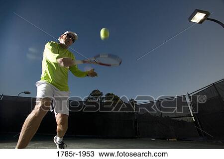 Tennis player hitting a backhand View Large Photo Image Stock Image - Tennis player hitting a backhand. Fotosearch