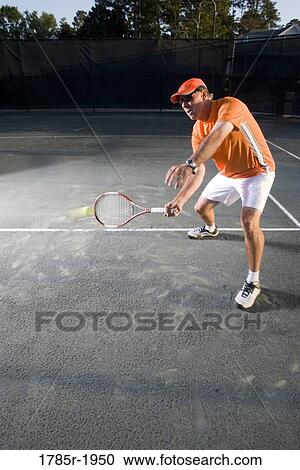 Tennis player hitting a volley at the service line View Large Photo Image Stock Image - Tennis player hitting a volley at the service line. Fotosearch