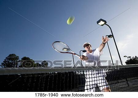 Tennis player hitting a volley View Large Photo Image Stock Image - Tennis player hitting a volley. Fotosearch