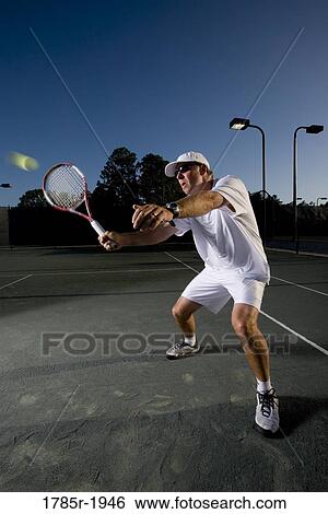 Tennis player hitting a volley View Large Photo Image Stock Photograph - Tennis player hitting a volley. Fotosearch