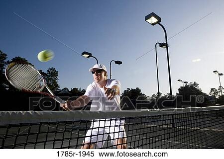 Tennis player hitting a volley View Large Photo Image Stock Photography - Tennis player hitting a volley. Fotosearch