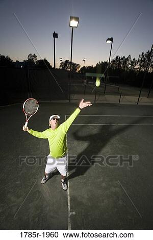Stock Image - Tennis player serving. Fotosearch