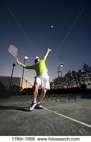 Stock Photo - Tennis player serving. Fotosearch