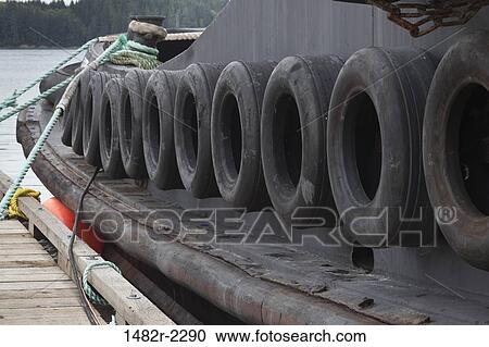 Stock Image - Tires on a tugboat at a port, Port McNeill, Vancouver Island, British Columbia, Canada. Fotosearch