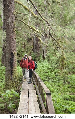 Tourists passing through a footbridge, Naha Bay, Alaska, USA View Large Photo Image Stock Image - Tourists passing through a footbridge, Naha Bay, Alaska, USA. Fotosearch