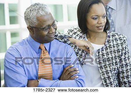 Stock Photo - Two African American business people standing together. Fotosearch
