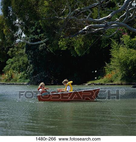 Two children sitting in a boat View Large Photo Image Stock Photograph - Two children sitting in a boat. Fotosearch
