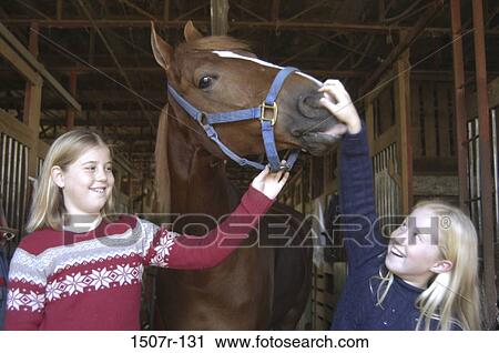 Two girls with a horse View Large Photo Image Stock Image - Two girls with a horse. Fotosearch