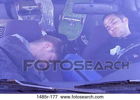 Two men sleeping in a car View Large Photo Image Stock Photo - Two men sleeping in a car. Fotosearch
