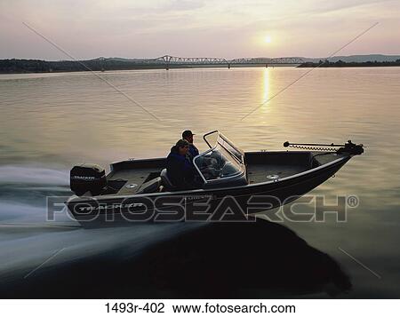 Two people in a motorboat View Large Photo Image Stock Image - Two people in a motorboat. Fotosearch