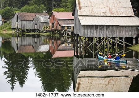 Stock Photo - Two people kayaking in a river, Hammer Slough, Petersburg, Alaska, USA. Fotosearch