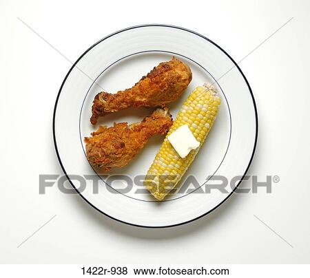 Two pieces of fried chicken and buttered corn on the cob on plate View Large Photo Image Stock Photo - Two pieces of fried chicken and buttered corn on the cob on plate. Fotosearch