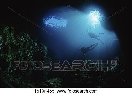 Stock Photography - Two scuba divers swimming underwater. Fotosearch