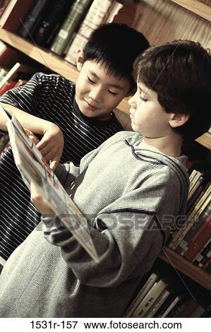 Two students reading a book View Large Photo Image Stock Photo - Two students reading a book. Fotosearch