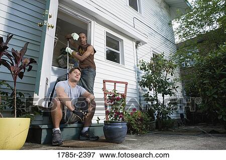 Two young men doing house chores View Large Photo Image Stock Photo - Two young men doing house chores. Fotosearch