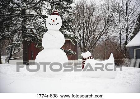 Stock Photo - USA, New Jersey, Hunterdon County, Snowman and snow dog. Fotosearch