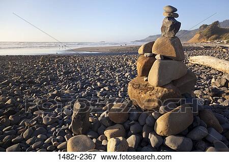 Stock Photo - USA, Oregon, Coast Devil's Punchbowl State Natural Area, Pebble beach at sunset. Fotosearch