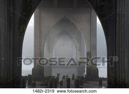 Stock Photo - USA, Oregon, Florence, Siuslaw River Bridge at sunrise. Fotosearch