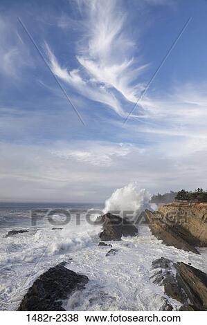 Stock Photo - USA, Oregon, Shore Acres State Park, Ocean waves crashing against cliff. Fotosearch