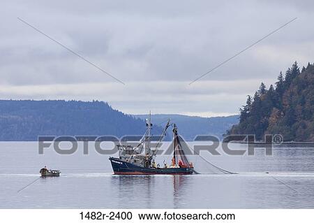 Stock Image - USA, Washington, Seabeck, Fishermen in boat on Hood Canal. Fotosearch