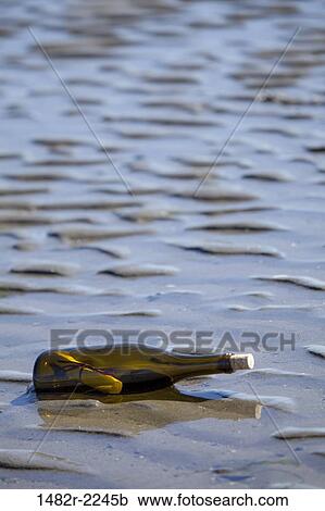 Stock Image - USA, Washington State, Hansville, Point No Point, Kitsap County, message in a bottle. Fotosearch
