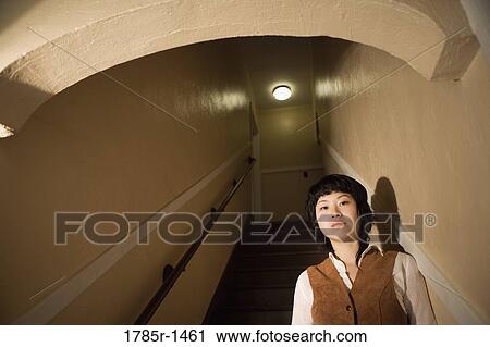 View of a young Asian woman at bottom of staircase View Large Photo Image Stock Image - View of a young Asian woman at bottom of staircase. Fotosearch
