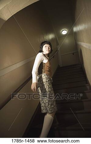 View of a young Asian woman at bottom of staircase View Large Photo Image Stock Photo - View of a young Asian woman at bottom of staircase. Fotosearch