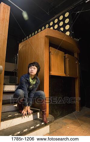 View of a young Asian woman sitting on steps View Large Photo Image Stock Photograph - View of a young Asian woman sitting on steps. Fotosearch