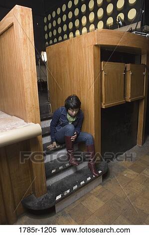 View of a young Asian woman sitting on steps View Large Photo Image Stock Photography - View of a young Asian woman sitting on steps. Fotosearch