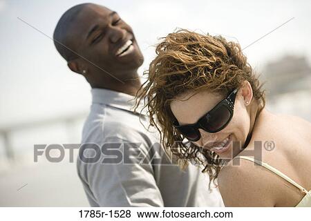 View of an exuberant young couple View Large Photo Image Stock Photo - View of an exuberant young couple. Fotosearch