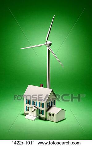 Wind turbine with a house in a green environment View Large Photo Image Stock Image - Wind turbine with a house in a green environment. Fotosearch