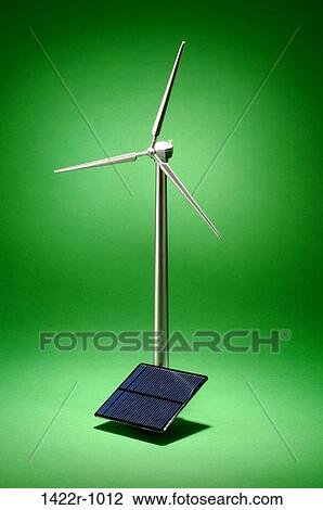 Wind turbine with a small solar panel in a green environment View Large Photo Image Stock Image - Wind turbine with a small solar panel in a green environment. Fotosearch