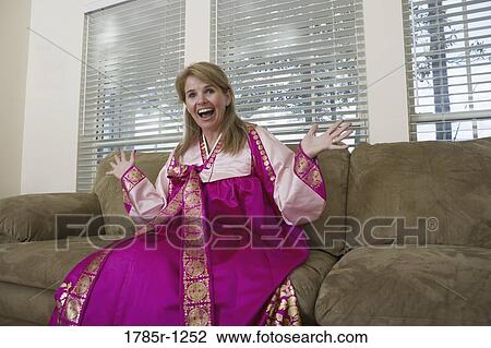 Woman in living room wearing a Hanbok, a traditional Korean costume View Large Photo Image Stock Image - Woman in living room wearing a Hanbok, a traditional Korean costume. Fotosearch