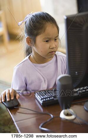 Young Asian giirl using computer View Large Photo Image Stock Photo - Young Asian giirl using computer. Fotosearch