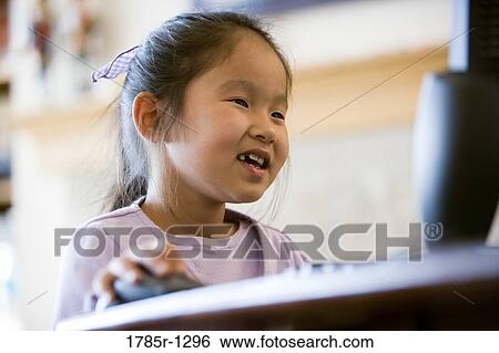 Young Asian giirl using computer View Large Photo Image Stock Photograph - Young Asian giirl using computer. Fotosearch