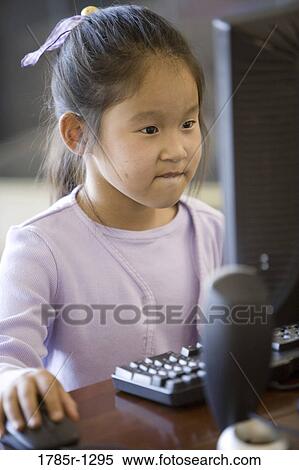 Young Asian giirl using computer View Large Photo Image Stock Photography - Young Asian giirl using computer. Fotosearch