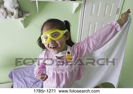 Young Asian girl in super-hero costume standing on bed View Large Photo Image Stock Image - Young Asian girl in super-hero costume standing on bed. Fotosearch