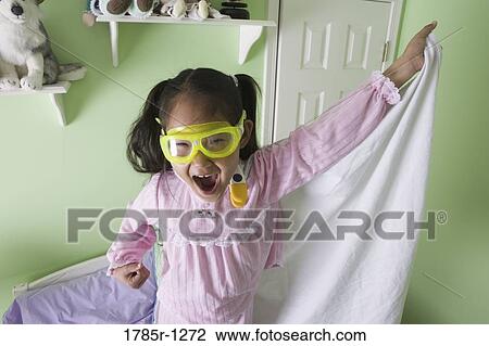 Young Asian girl in super-hero costume standing on bed View Large Photo Image Stock Image - Young Asian girl in super-hero costume standing on bed. Fotosearch