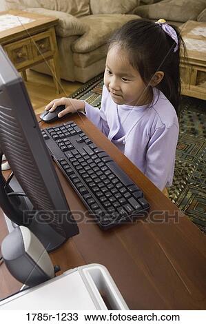 Young Asian girl using computer View Large Photo Image Stock Image - Young Asian girl using computer. Fotosearch