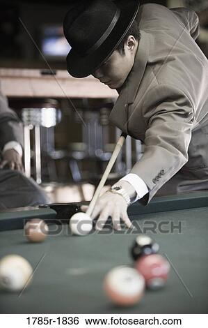 Young Asian man playing billiards View Large Photo Image Stock Photograph - Young Asian man playing billiards. Fotosearch