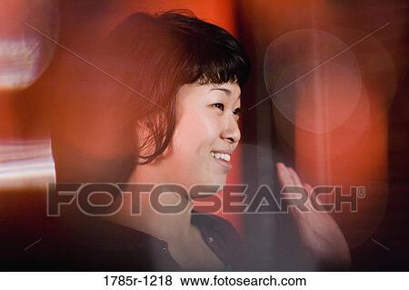 Young Asian woman waving her hand smilingly View Large Photo Image Stock Photo - Young Asian woman waving her hand smilingly. Fotosearch