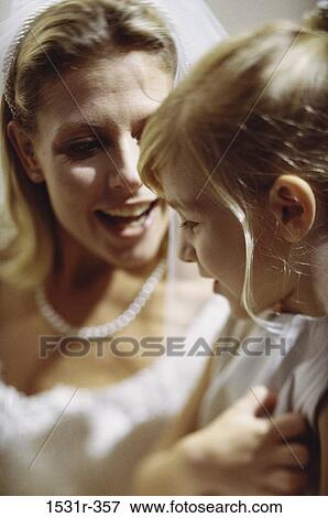 Stock Photo - Young bride talking with a child. Fotosearch