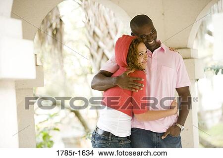 Young couple embracing while standing in a gazebo View Large Photo Image Picture - Young couple embracing while standing in a gazebo. Fotosearch